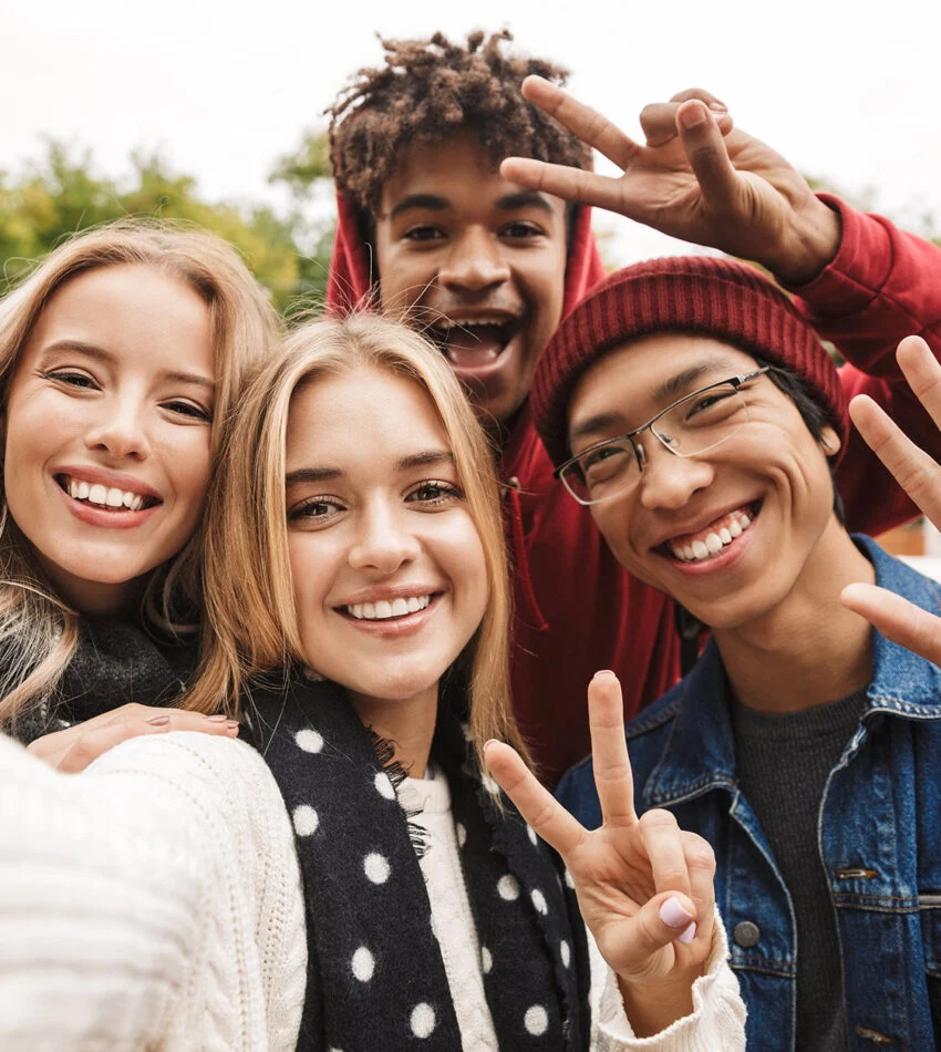 Teens laughing and taking a group selfie
