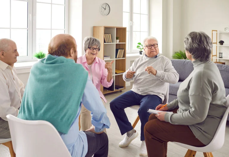 Older adults talking together in a bright small group room