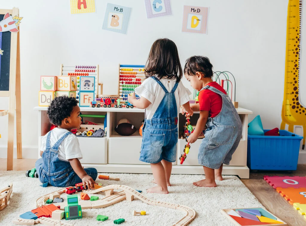 Children playing in a bright kids classroom